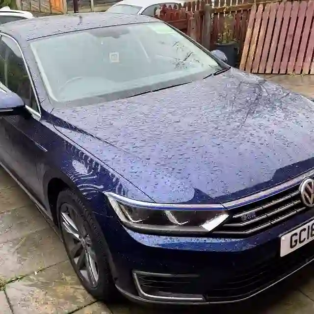 A dark blue VW Passat on a driveway — one of AutoDr's own photos
